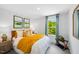 Cozy bedroom featuring ample natural light, stylish decor, and comfortable furnishings at 410 Rowe Way, Knightdale, NC 27545