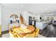 Open-concept dining area with modern decor, wood table and seamless access to the kitchen at 410 Rowe Way, Knightdale, NC 27545