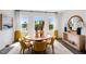 Inviting dining room with contemporary decor, large windows, and stylish furnishings at 410 Rowe Way, Knightdale, NC 27545