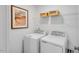Functional laundry room with washer, dryer, and shelving for storage at 410 Rowe Way, Knightdale, NC 27545