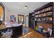 Bedroom featuring hardwood floors, custom bookcase, and natural light at 417 S Fourth St, Mebane, NC 27302