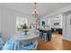 Charming dining area with hardwood floors, chandelier, and view into the kitchen at 417 S Fourth St, Mebane, NC 27302