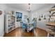 Cozy dining area with a floral table setting, next to a sideboard, and a view to the kitchen at 417 S Fourth St, Mebane, NC 27302