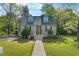 Charming home showcasing a manicured lawn, vibrant landscaping, and a welcoming entrance with a new concrete pathway at 417 S Fourth St, Mebane, NC 27302