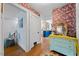 Hallway featuring hardwood floors and bright, colorful decor with a view to the kitchen at 417 S Fourth St, Mebane, NC 27302