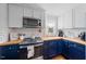Charming kitchen boasting modern appliances, butcher block countertops, and stylish cabinetry, perfect for culinary enthusiasts at 417 S Fourth St, Mebane, NC 27302