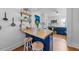 Charming kitchen features a breakfast bar, butcher block countertop, blue cabinets, and open shelving at 417 S Fourth St, Mebane, NC 27302