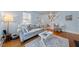 Cozy living room features a floral patterned sofa, light blue walls, and hardwood floors at 417 S Fourth St, Mebane, NC 27302