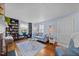 Bright living room featuring hardwood floors, built-in bookcase, and a floral sofa at 417 S Fourth St, Mebane, NC 27302