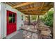 Cozy covered patio showcasing wicker furniture and a tranquil outdoor space, perfect for relaxing and enjoying the scenery at 417 S Fourth St, Mebane, NC 27302
