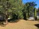 Mature trees offer shade on a large lot with a wooden bench at 4172 Copeland Ter, Graham, NC 27253