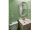 Compact bathroom featuring green walls, decorative mirror and a simple sink at 4172 Copeland Ter, Graham, NC 27253