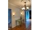 Dining area featuring elegant lighting, hardwood flooring, and sliding glass doors at 4172 Copeland Ter, Graham, NC 27253