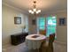 Inviting dining room with decorative chandelier, natural light, and neutral tones at 4172 Copeland Ter, Graham, NC 27253