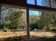 View from covered porch overlooking a large grassy front yard with lots of mature trees at 4172 Copeland Ter, Graham, NC 27253