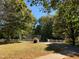 Large front yard with mature trees and a well at 4172 Copeland Ter, Graham, NC 27253