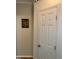 Hallway with decorative wall art and a white paneled door with brushed hardware at 4172 Copeland Ter, Graham, NC 27253