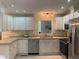 Bright kitchen features white cabinets, modern appliances, and ample counter space at 4172 Copeland Ter, Graham, NC 27253