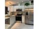 Bright kitchen featuring stainless appliances, white cabinetry, and modern lighting at 4172 Copeland Ter, Graham, NC 27253
