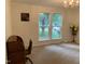 Inviting living room with bright windows, neutral carpet, and classic chandelier at 4172 Copeland Ter, Graham, NC 27253