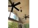 Relaxing covered patio featuring ceiling fans and an overhead light at 4172 Copeland Ter, Graham, NC 27253