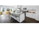 Open-concept kitchen with a center island, bar stool seating, and stainless appliances at 418 Rowe Way, Knightdale, NC 27545