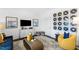 Stylish living room with vinyl record art, modern furniture, and a gray patterned rug at 418 Rowe Way, Knightdale, NC 27545