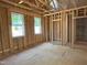 Unfinished bedroom showcases wood framing and two windows allowing natural light to stream in at 485 Chapel Ridge Dr, Pittsboro, NC 27312