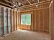 Unfinished bedroom featuring wood framing, a single window, and the subfloor at 485 Chapel Ridge Dr, Pittsboro, NC 27312