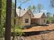 Exterior framing of new home showing covered porch and surrounding wooded area at 485 Chapel Ridge Dr, Pittsboro, NC 27312