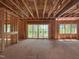 Framing of a living room featuring large windows and sliding glass doors to a wooded area at 485 Chapel Ridge Dr, Pittsboro, NC 27312