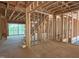 Open floor plan framing shows staircase and large windows, future living space at 485 Chapel Ridge Dr, Pittsboro, NC 27312