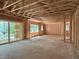 Large room under construction with wood framing and multiple windows overlooking wooded area at 485 Chapel Ridge Dr, Pittsboro, NC 27312