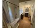 Bathroom features shower and tub combo and a wood vanity at 529 Sunset Dr, Fuquay Varina, NC 27526