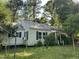 Cozy home with green shutters, surrounded by trees, and a spacious yard at 529 Sunset Dr, Fuquay Varina, NC 27526