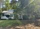 Quaint home featuring a metal roof, surrounded by mature trees and a spacious front yard at 529 Sunset Dr, Fuquay Varina, NC 27526