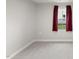 A cozy bedroom showing carpeted floors and a bright window with dark red curtains at 55 Boots Ridge Way, Franklinton, NC 27525