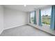 Bright, carpeted bedroom with large windows adorned with light blue curtains for a serene touch at 55 Boots Ridge Way, Franklinton, NC 27525