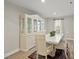 Dining room features white table and chairs, a large china cabinet, and a window with natural light at 55 Boots Ridge Way, Franklinton, NC 27525