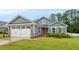 Charming single-story home with a well-manicured lawn, attached garage, and inviting red front door at 55 Boots Ridge Way, Franklinton, NC 27525