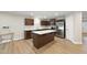 Modern kitchen featuring stainless steel appliances, a central island, and ample cabinet space at 55 Boots Ridge Way, Franklinton, NC 27525