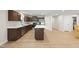 Modern kitchen featuring stainless appliances, an island with white countertop, and brown cabinets at 55 Boots Ridge Way, Franklinton, NC 27525