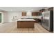 Open kitchen with a large island, stainless steel appliances, and a view into the combined living area at 55 Boots Ridge Way, Franklinton, NC 27525