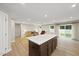 Open-concept living area showcasing the flow between the kitchen island, living room, and dining area at 55 Boots Ridge Way, Franklinton, NC 27525