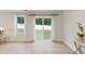 Bright living room with large windows and hardwood floors, providing ample natural light and backyard views at 55 Boots Ridge Way, Franklinton, NC 27525