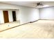 Spacious basement with carpet flooring, ceiling fan, and large mirror at 5500 Fortunes Ridge Dr # 82B, Durham, NC 27713