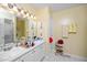 Bright bathroom has double sinks with storage, a large mirror, and tile flooring at 5500 Fortunes Ridge Dr # 82B, Durham, NC 27713