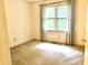 Bright and cozy bedroom with light carpet and natural light flooding through the window at 5500 Fortunes Ridge Dr # 82B, Durham, NC 27713