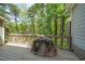 Wood deck has a brown-covered grill and a wood railing overlooking a green forested area at 5500 Fortunes Ridge Dr # 82B, Durham, NC 27713
