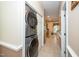 Hallway featuring an in-unit washer and dryer and tile flooring leading to the kitchen at 5500 Fortunes Ridge Dr # 82B, Durham, NC 27713